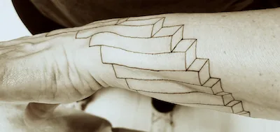 forearm with tattoo of offset rectangular blocks
