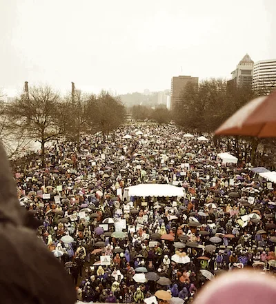Overhead view of a packed crowd along a waterfront.