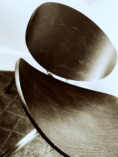 A lounge chair with a curved backrest and curved seat.