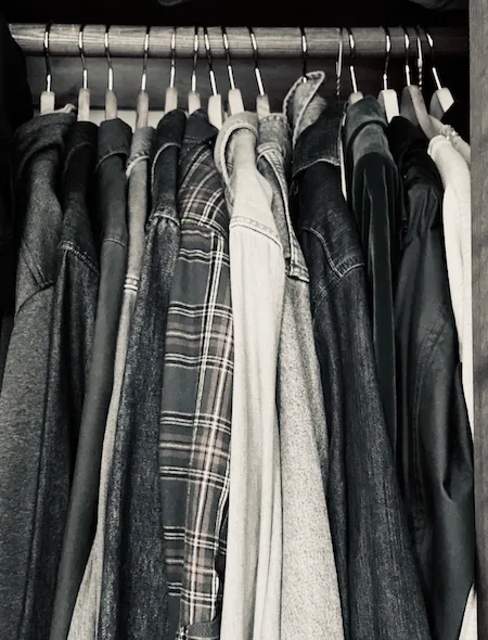 A clothing rod packed with shirts on hangers